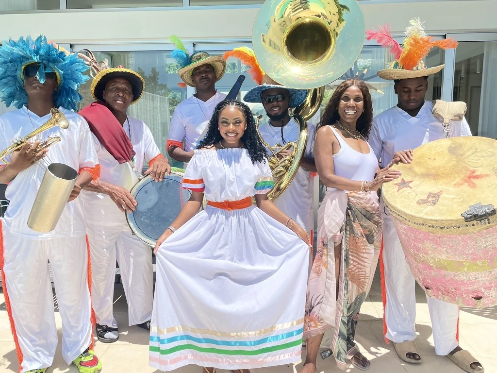 Island Mystique founder Mary Fulford with cultural performers and musicians in colourful island dress