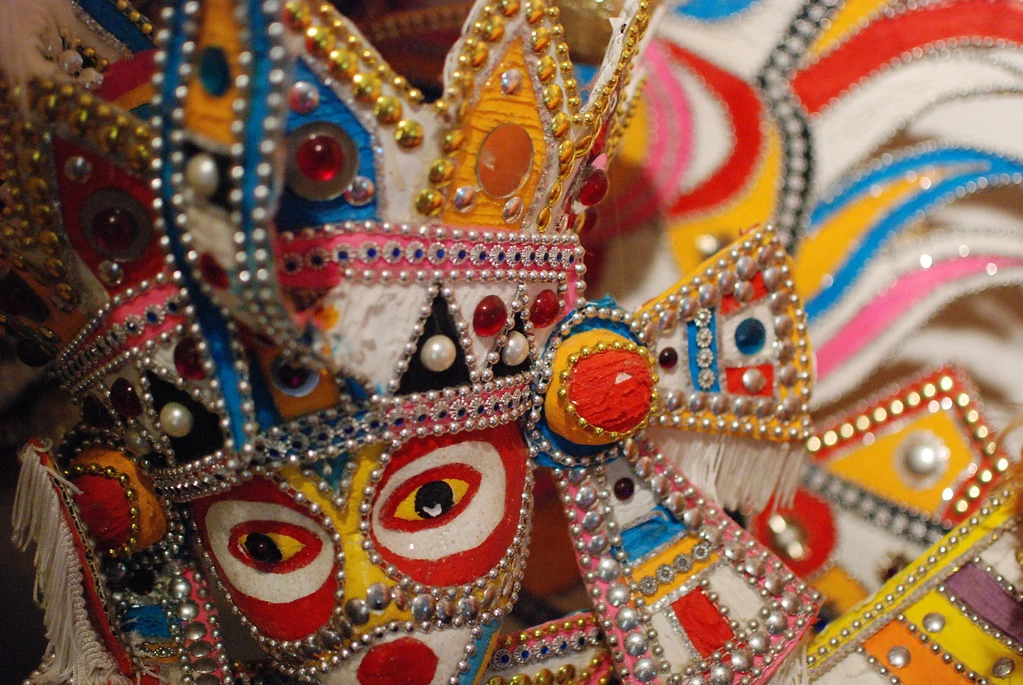 Close-up of a colourful handmade Junkanoo mask decorated with beads and sparkling details