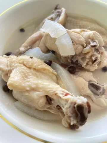 A traditional chicken dish with onion served in a white bowl